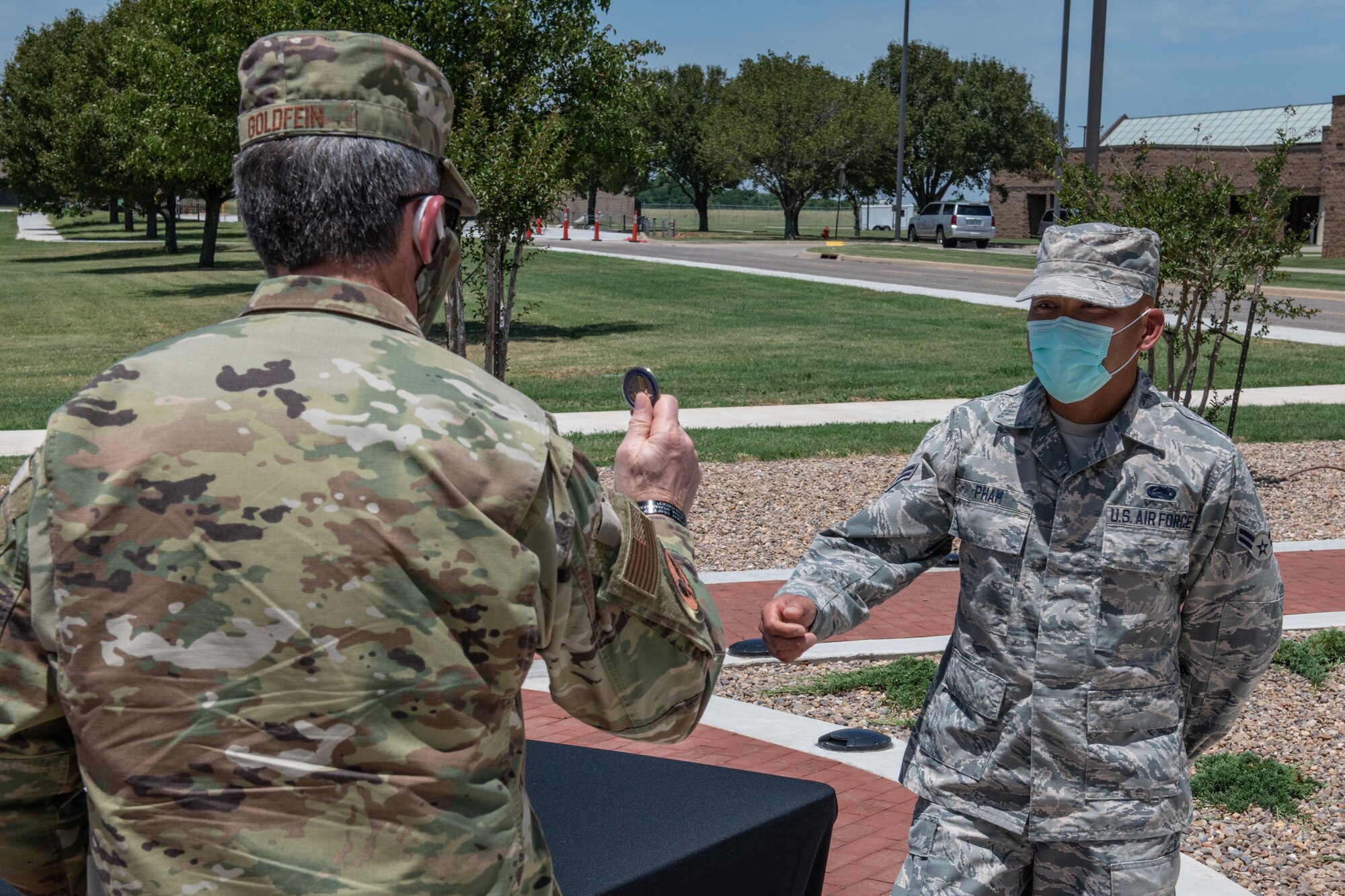 Air Force Chief of Staff Gen. David L. Goldfein bumps coins Airman 1st Class Binh Pham, a radar, airfield and weather systems Airman for the 205th Engineering and Installation Squadron, during a base tour on June 8, 2020, at Will Rogers Air National Guard Base in Oklahoma City. Pham was nominated to receive a coin from Goldfein for his exceptional contributions as a Guardsman serving at the Regional Food Bank of Oklahoma during the state’s response to COVID-19. (U.S. Air National Guard photo by Senior Master Sgt. Andrew M. LaMoreaux)