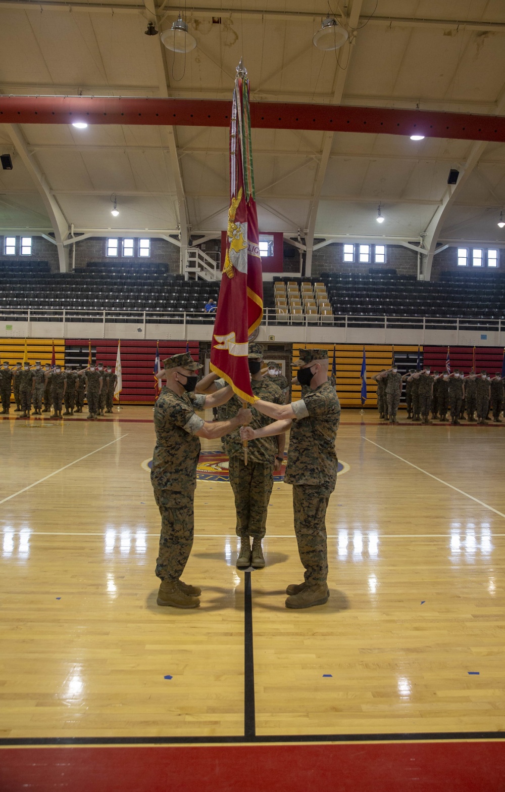 U.S. Marine Corps Lt. Col. Christopher Conner, right, and Lt. Col. Scott Cuomo, left, both with 2D Light Armored Reconnaissance Battalion, 2D Marine Division exchange the battalion battle colors during the change of command ceremony on Camp Lejeune, North Carolina, July 09, 2020.