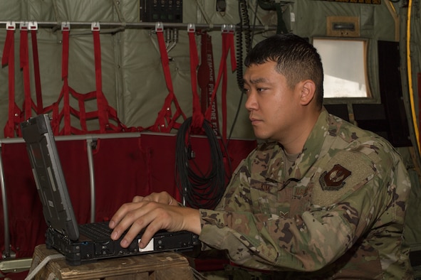 An Airman typing on a computer.