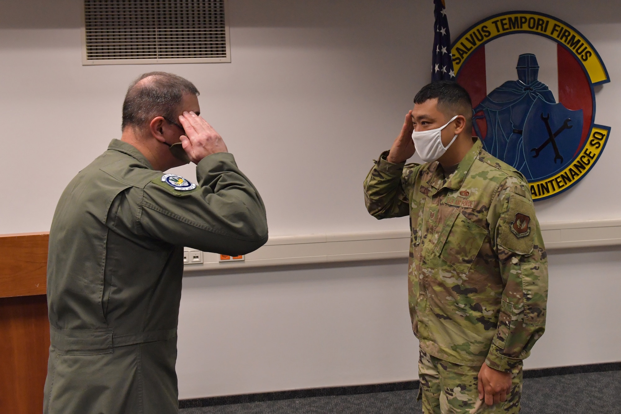 Two Airmen saluting.