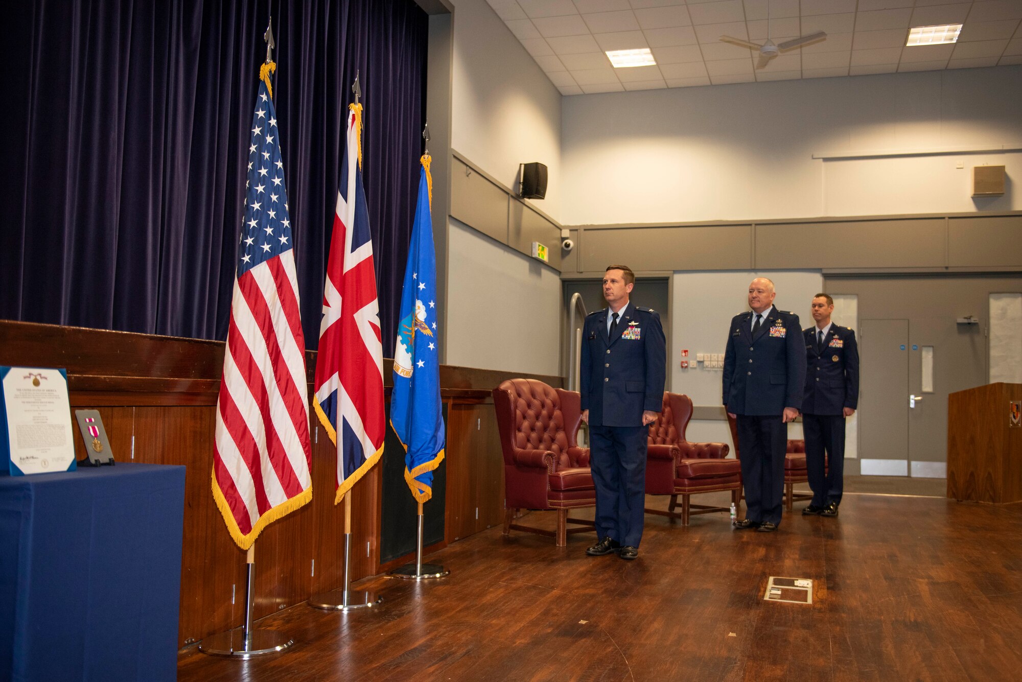 U.S. Air Force Col. Jon Hannah (left), 422d Air Base Group commander, Lt. Col. Matthew Ramstack (center), 422nd Air Base Squadron outgoing commander, and Maj. Timothy Kirchner (right), 422nd ABS incoming commander, stand at attention for the playing of the national anthem during a change of command ceremony at RAF Croughton, England, July 9, 2020. The change of command ceremony is rooted in military history dating back to the 18th century representing the relinquishing of power from one officer to another. (U.S. Air Force photo by Airman 1st Class Jennifer Zima)