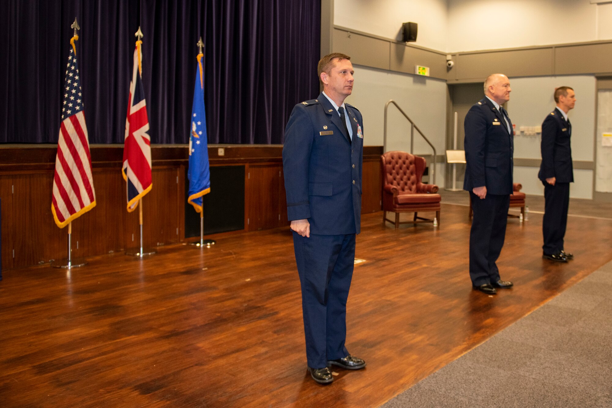 U.S. Air Force Col. Jon Hannah (left), 422d Air Base Group commander, Lt. Col. Matthew Ramstack (center), 422nd Air Base Squadron outgoing commander and Maj. Timothy Kirchner (right), 422nd ABS incoming commander, stand at attention during a change of command ceremony at RAF Croughton, England, July 9, 2020. The change of command ceremony is rooted in military history dating back to the 18th century representing the relinquishing of power from one officer to another. (U.S. Air Force photo by Airman 1st Class Jennifer Zima)
