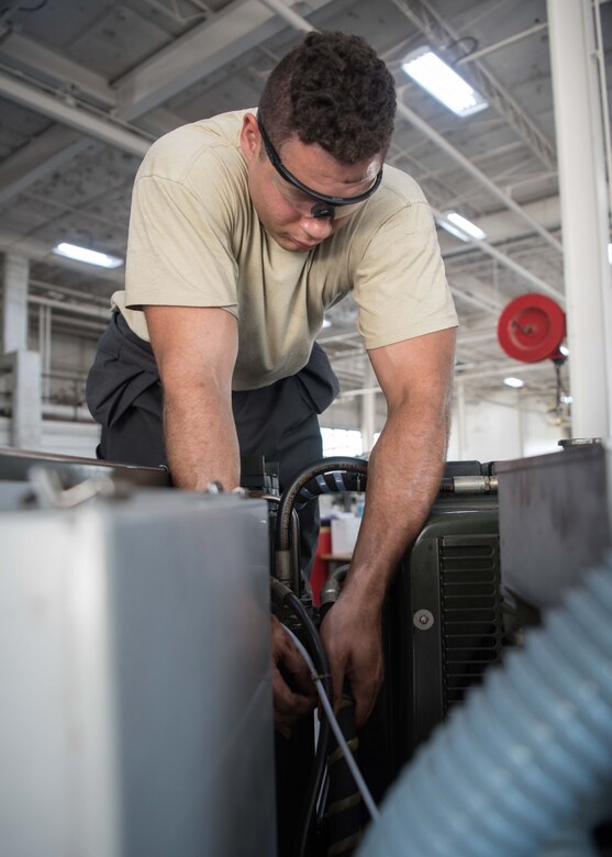 Senior Airman Nicholas Summit, 22nd Maintenance Squadron aerospace ground equipment journeyman, secures a chafe wrap on a self-generating nitrogen cart July 7, 2020, at McConnell Air Force Base, Kansas. Summit was ensuing that the self-generating nitrogen cart was working properly by changing the hydraulic filter and securing the nitrogen cart components. (U.S. Air Force photo by Senior Airman Alexi Bosarge)
