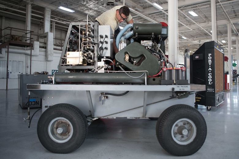 Senior Airman Nicholas Summit, 22nd Maintenance Squadron aerospace ground equipment journeyman, inspects wiring on a self-generating nitrogen cart July 7, 2020, at McConnell Air Force Base, Kansas. Nitrogen carts are capable of producing approximately 4400 psi the pneumatic servicing for tires on aircraft. (U.S. Air Force photo by Senior Airman Alexi Bosarge)