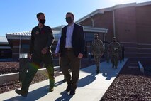 Col. Stephen R. Jones, 432nd Wing/432nd Air Expeditionary Wing commander, escorts U.S. Deputy Secretary of Defense David L. Norquist while departing Creech Air Force Base.