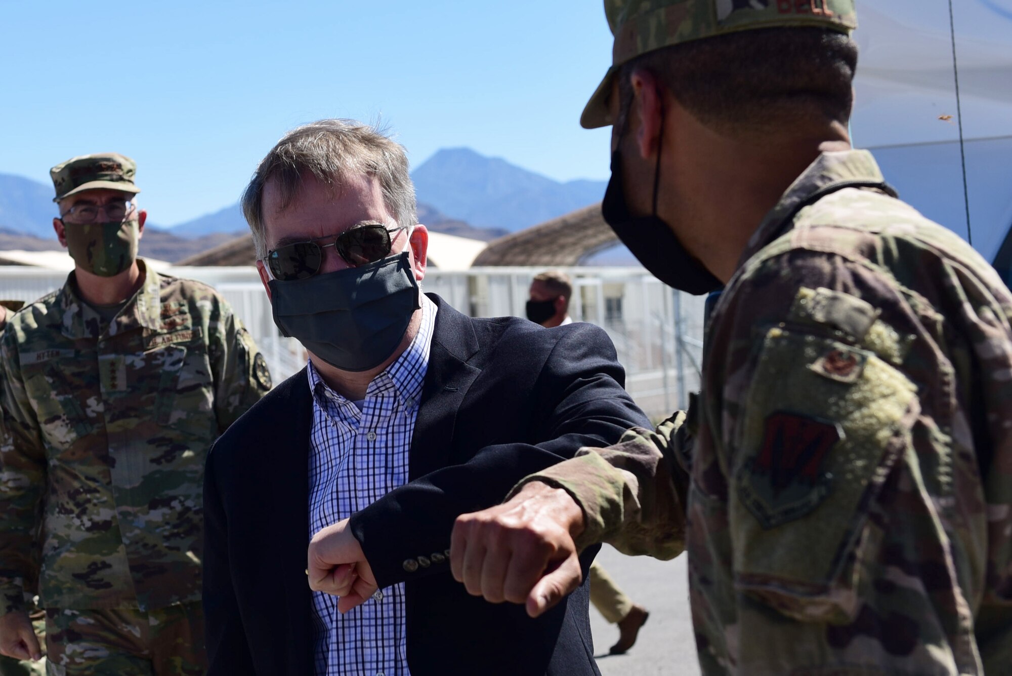 U.S. Deputy Secretary of Defense David L. Norquist walks alongside Col. Stephen R. Jones, 432nd Wing/432nd Air Expeditionary Wing commander, during a visit to Creech Air Force Base, Nevada.