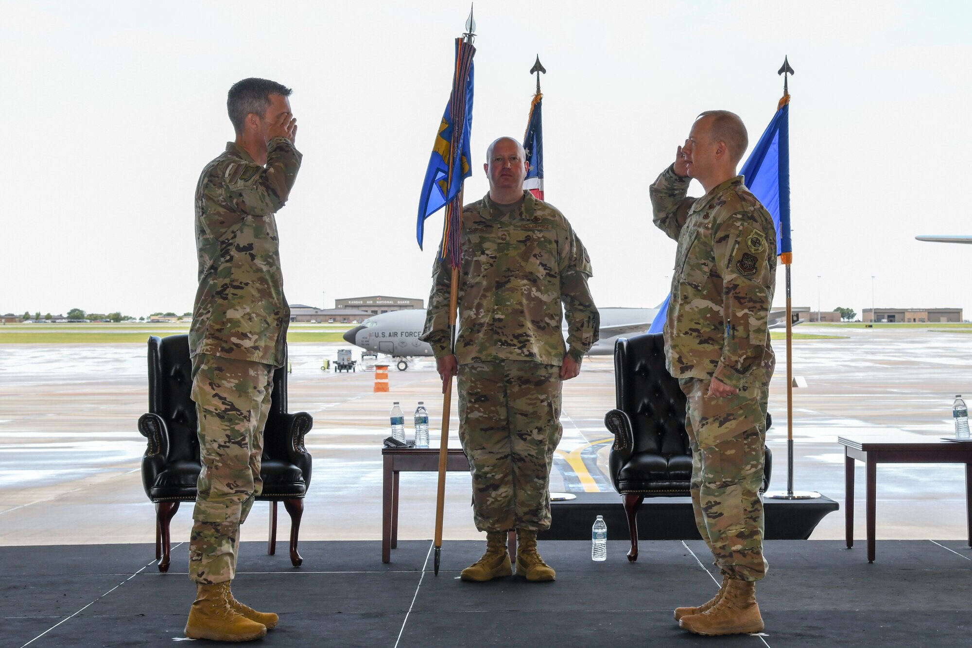 Col. Jonathan Downing, outgoing 22nd Maintenance Group commander, right, relinquishes command during a change of command ceremony July 9, 2020, at McConnell Air Force Base, Kansas.