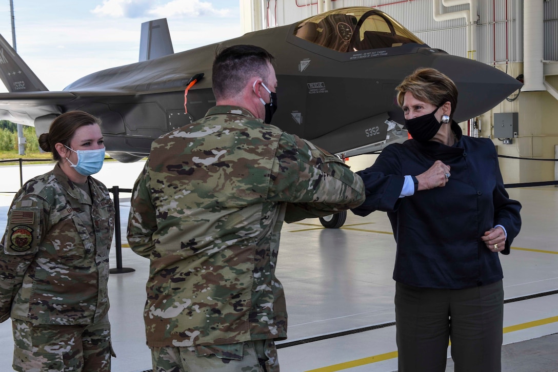 354th Aircraft Maintenance Squadron F-35A Lightning II production superintendent, bumps elbows with Secretary of the Air Force