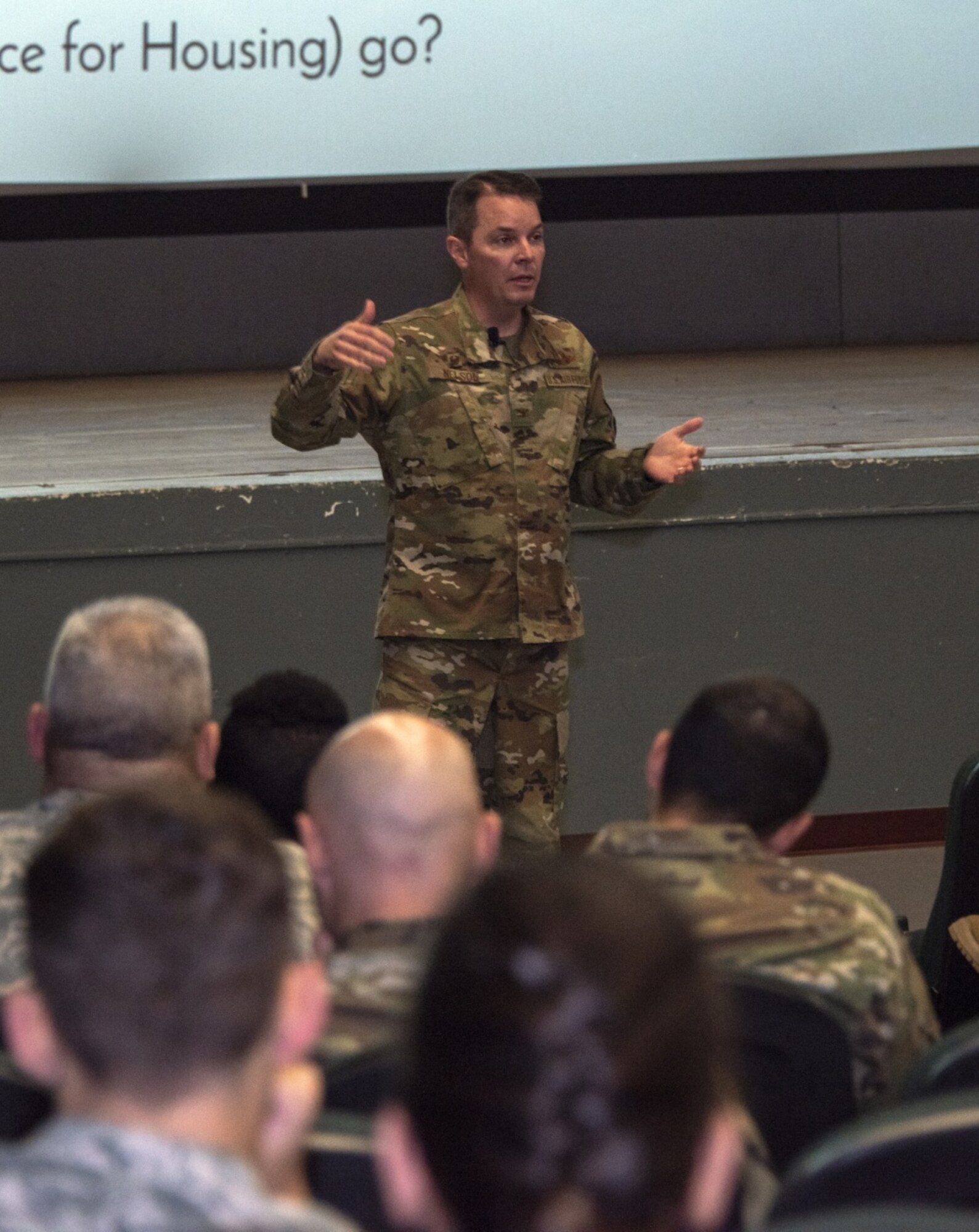 A man stands in front of a crowd.