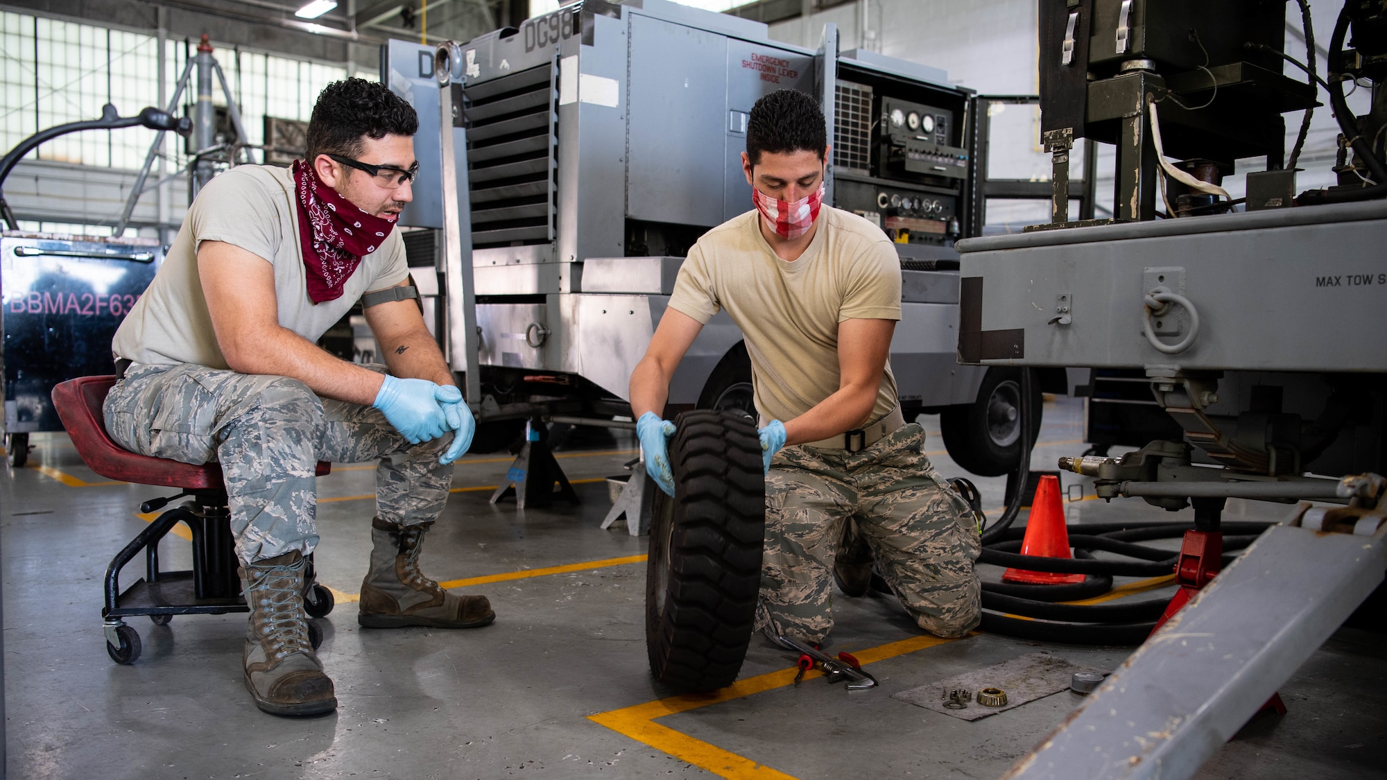 Senior Airman Benjamin A. Malian, 2nd Maintenance Squadron aerospace ground equipment craftsman, and Airman 1st Class Isaiah E. Nieves, 2nd MXS AGE journeyman, replace a tire on a -95 start cart at Barksdale Air Force Base, La., June 10, 2020. Second MXS AGE mechanics maintain and repair all the equipment that is used to service Barksdale's B-52H Stratofortresses. (U.S. Air Force photo by Airman 1st Class Jacob B. Wrightsman)