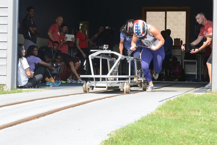 A bobsledder pushes her sled on a competition track.