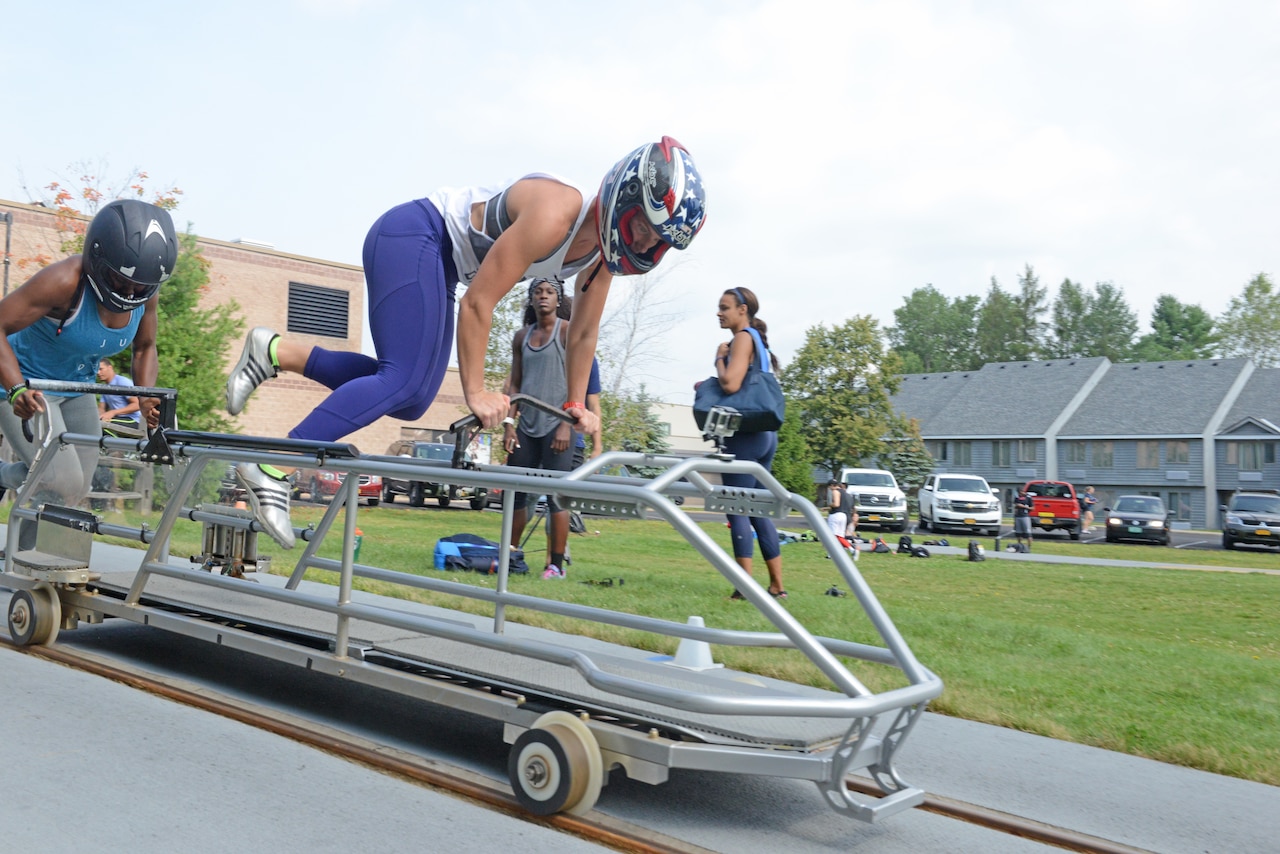 Bobsledders barrel down a railway track.