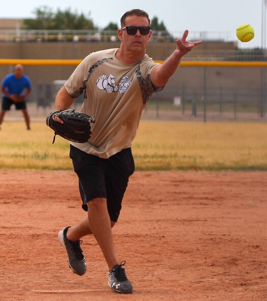 Harold Wilson, 25th Space Range Squadron superintendent, lobs the ball to the batter during an intramural softball game July 7, 2020, at Schriever Air Force Base, Colorado. The 4th Space Operations Squadron won the contest 15-7 in the season opener against U.S. Air Force Warfare Center. (U.S. Air Force photo by Marcus Hill)