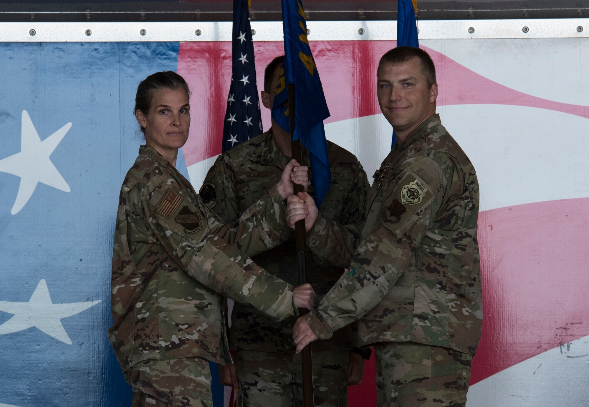 Col. Leah Fry, 4th Maintenance Group commander, receives the guidon from Maj. Joshua Walton, outgoing 4th Component Maintenance Squadron commander, during the 4 CMS change of command ceremony at Seymour Johnson Air Force Base, North Carolina, July 10, 2020. According to Fry, Walton was instrumental in leading the 4 MXG to receiving a “Highly Effective” Air Combat Command Inspector General rating. (U.S. Air Force photo by Senior Airman Kenneth Boyton)