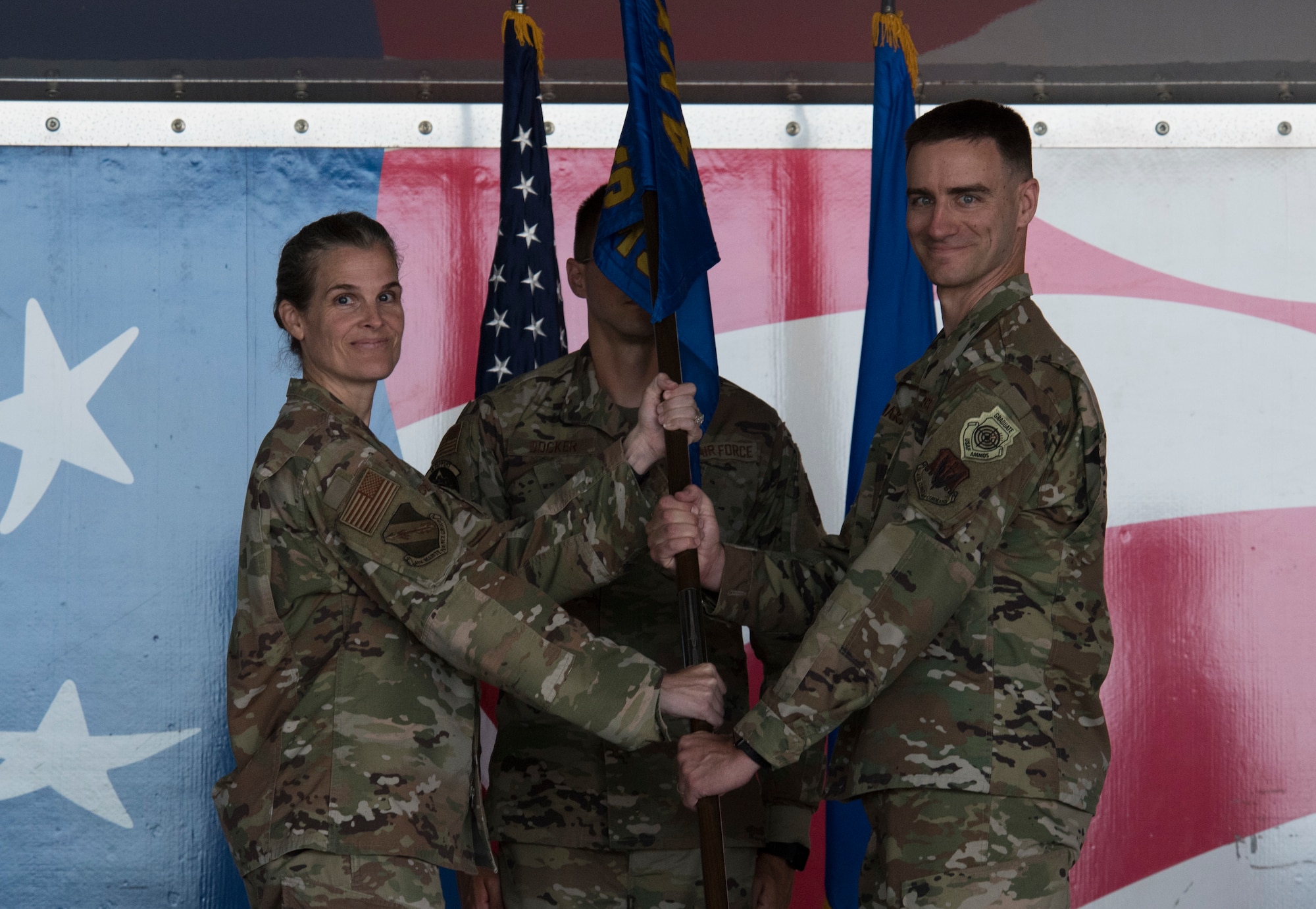 Col. Leah Fry, 4th Maintenance Group commander, passes the guidon to Maj. Michael Makaryk, incoming 4th Component Maintenance Squadron commander, during the 4 CMS change of command ceremony at Seymour Johnson Air Force Base, North Carolina, July 10, 2020. In attendance at the ceremony was Makaryk’s mother, father, wife and two sons. (U.S. Air Force photo by Senior Airman Kenneth Boyton)