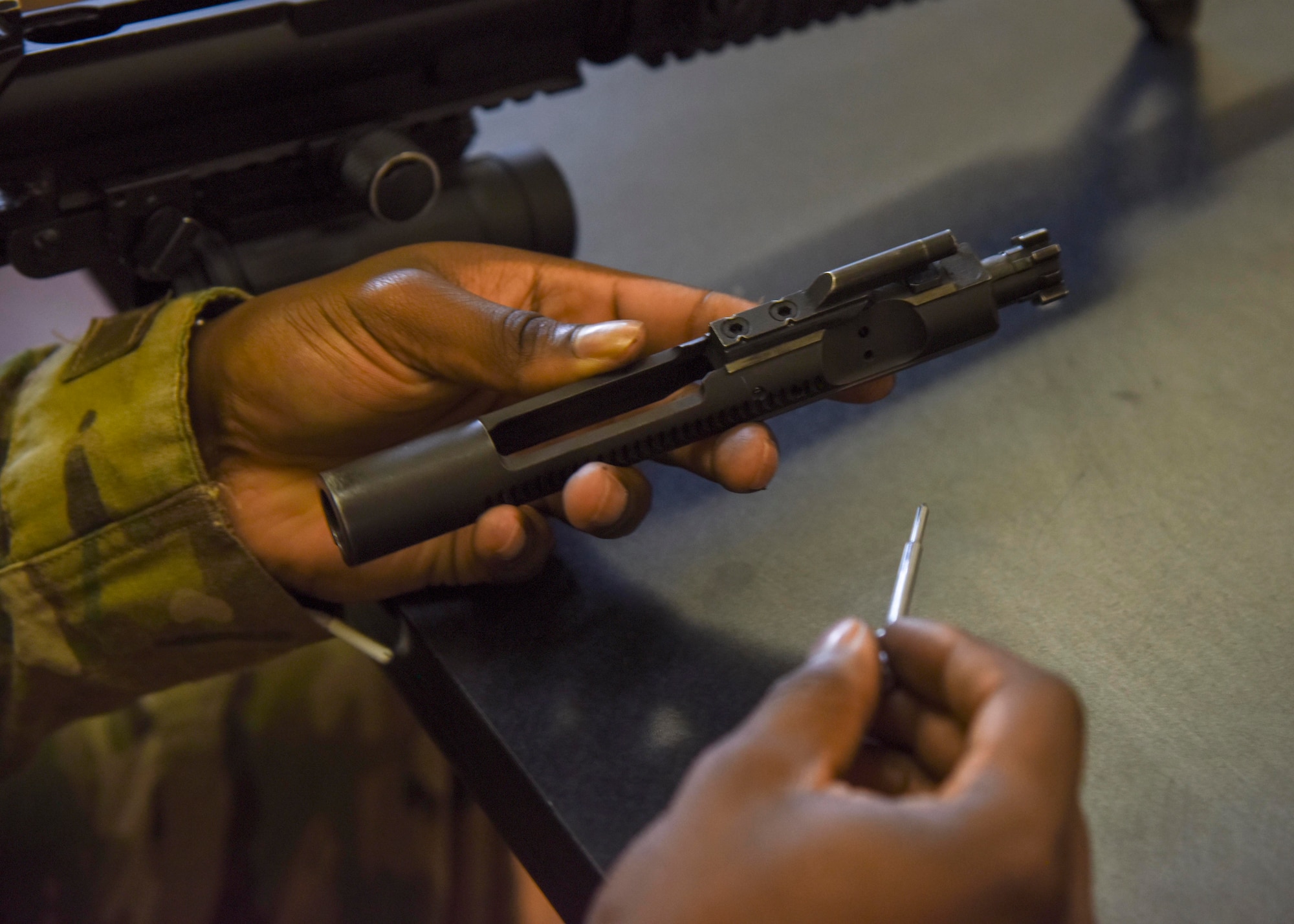 takes apart a M-4 carbine rifle