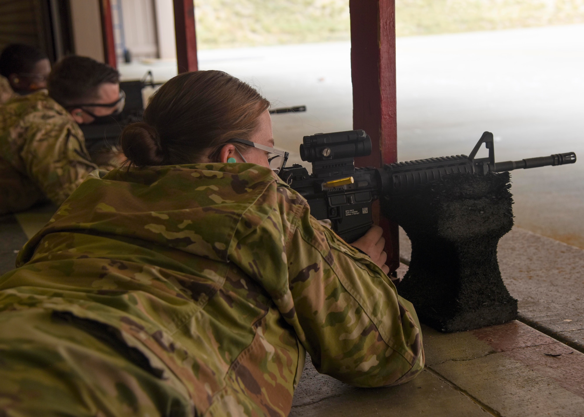 Airmen fire a M-4 carbine rifle for their qualification.