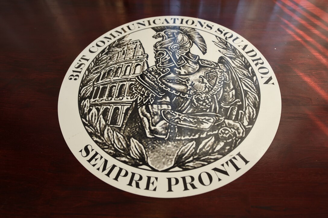 A 31st Communications Squadron logo is displayed at Aviano Air Base, Italy, July 9, 2020. The squadron adapted quickly to unique challenges during the COVID-19 crisis. (U.S. Air Force photo by Staff Sgt. Heidi Goodsell)