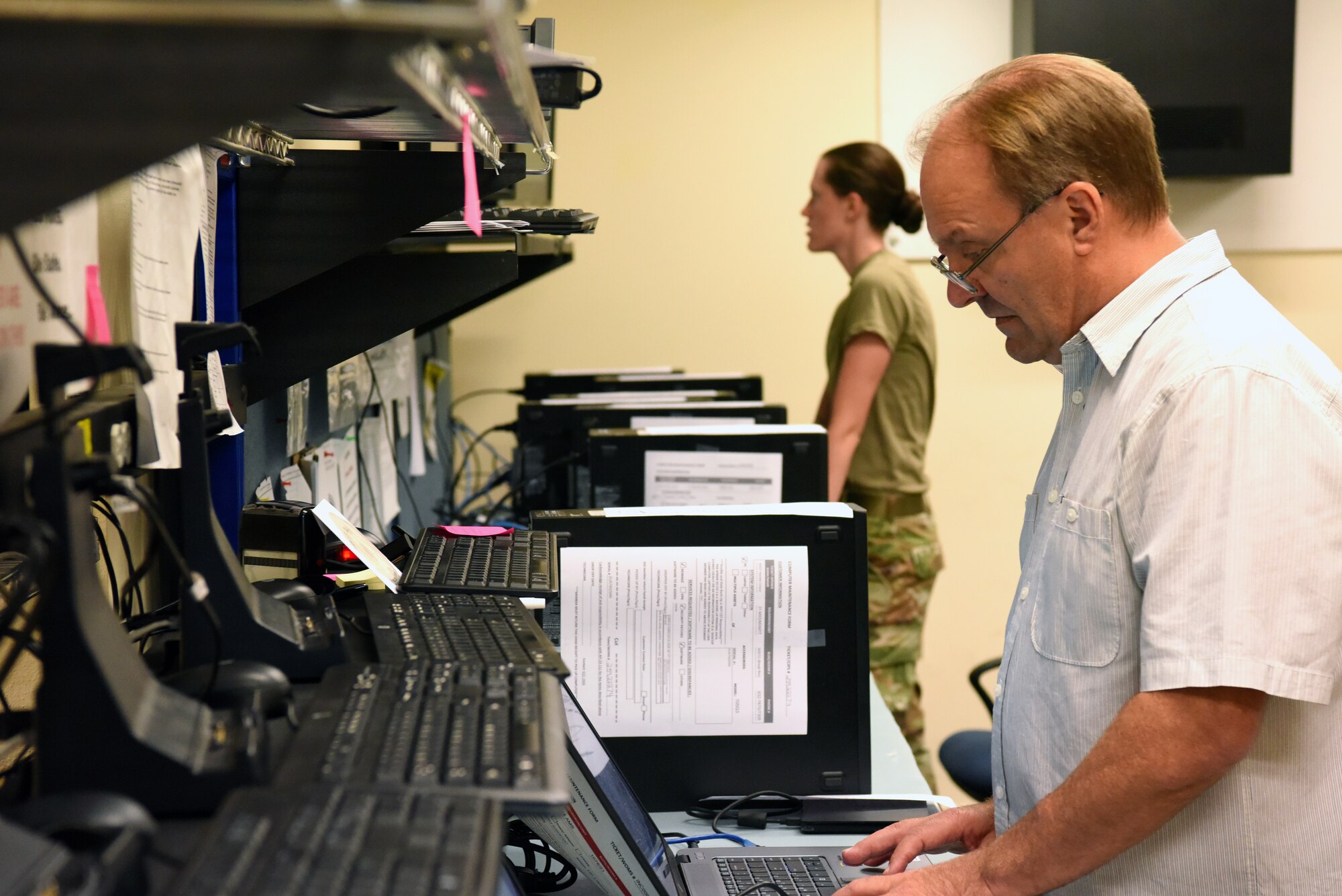 James Johnson and Airman 1st Class Savannah Coon, 31st Communications Squadron client systems technicians, reimage computers at Aviano Air Base, Italy, July 9, 2020. Reimaging computers was an important factor during the COVID-19 crisis. (U.S. Air Force photo by Staff Sgt. Heidi Goodsell)