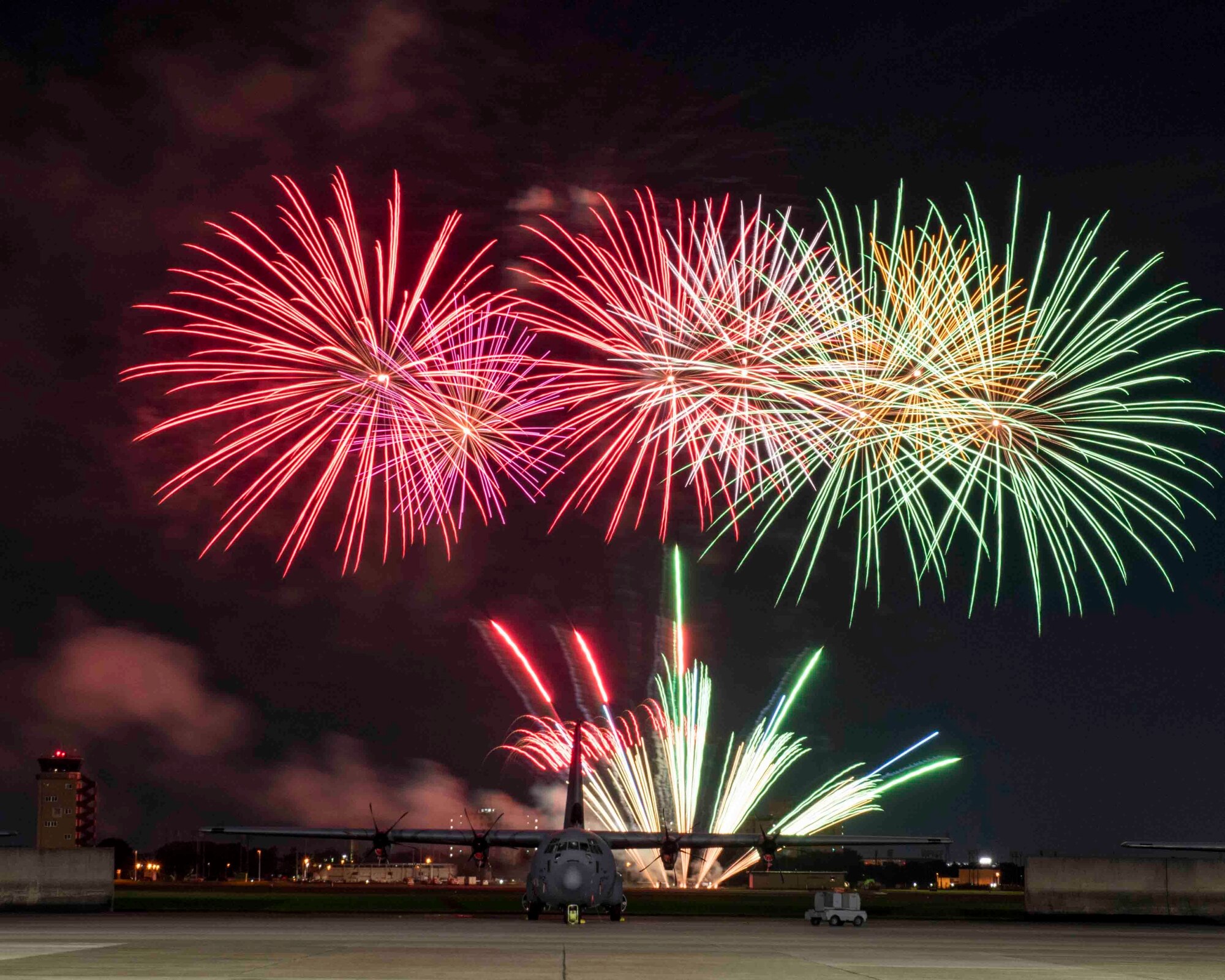 Fireworks explode behind a C-130J Super Hercules at Yokota Air Base, Japan, July 2, 2020.