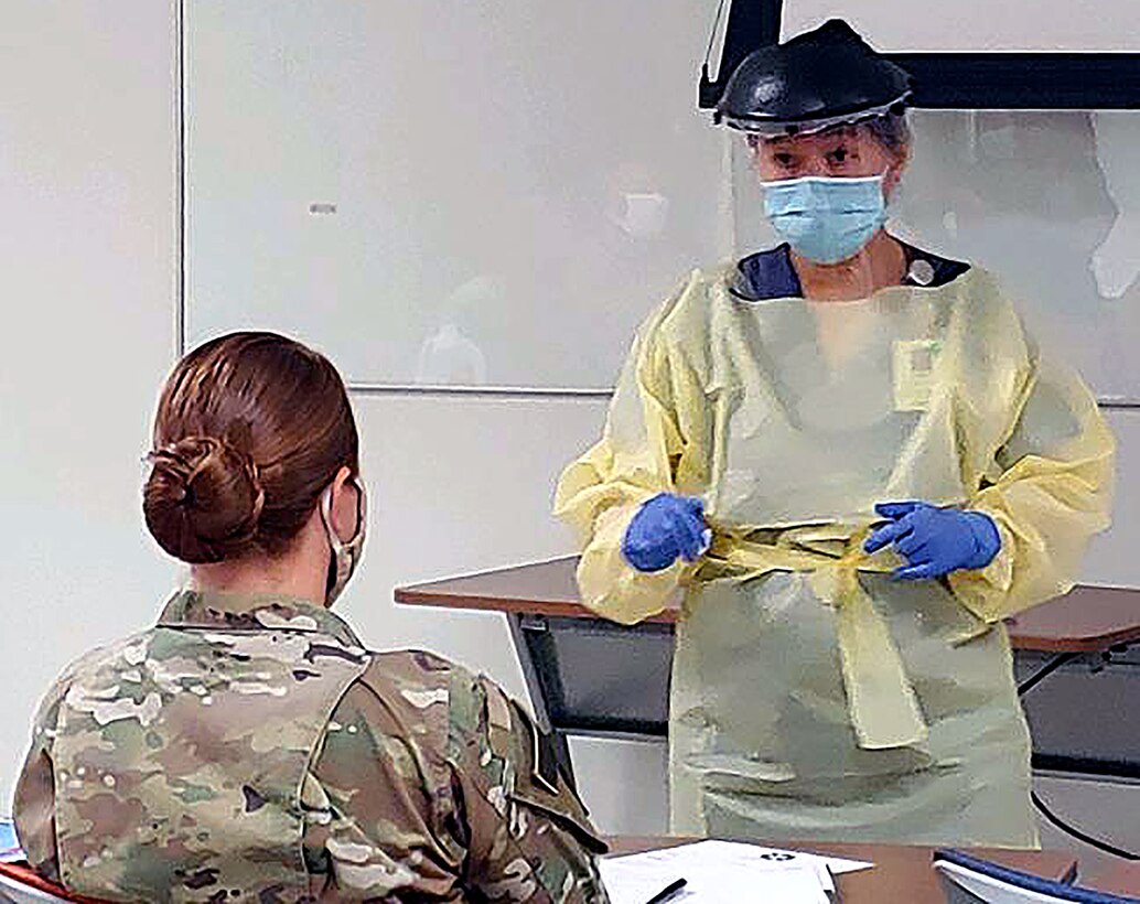 University Hospital integration trainer and Registered Nurse Helena Quezon shows the wear, removal and disposal of personal protective equipment