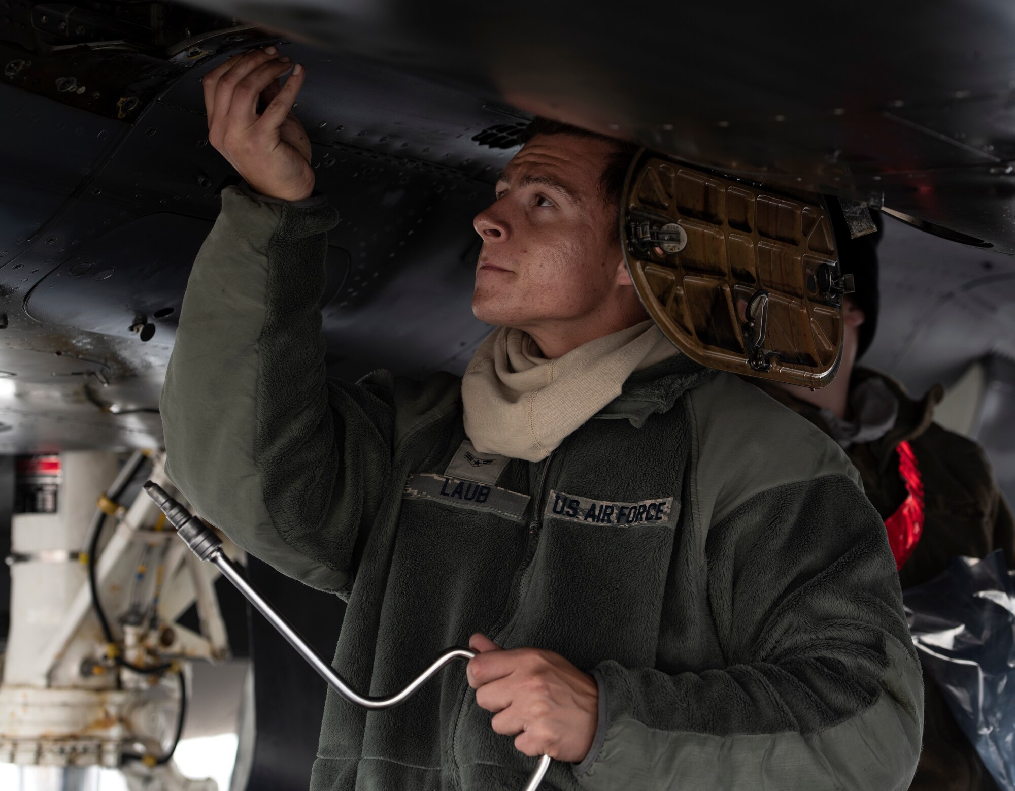 Airman 1st Class Hunter Laub, a 494th Fighter Squadron Aircraft Maintenance Unit crew chief, performs routine maintenance on an F-15E Strike Eagle at RAF Lakenheath, United Kingdom, June 10 2020.