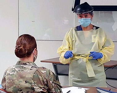 University Hospital integration trainer and Registered Nurse Helena Quezon shows the wear, removal and disposal of personal protective equipment