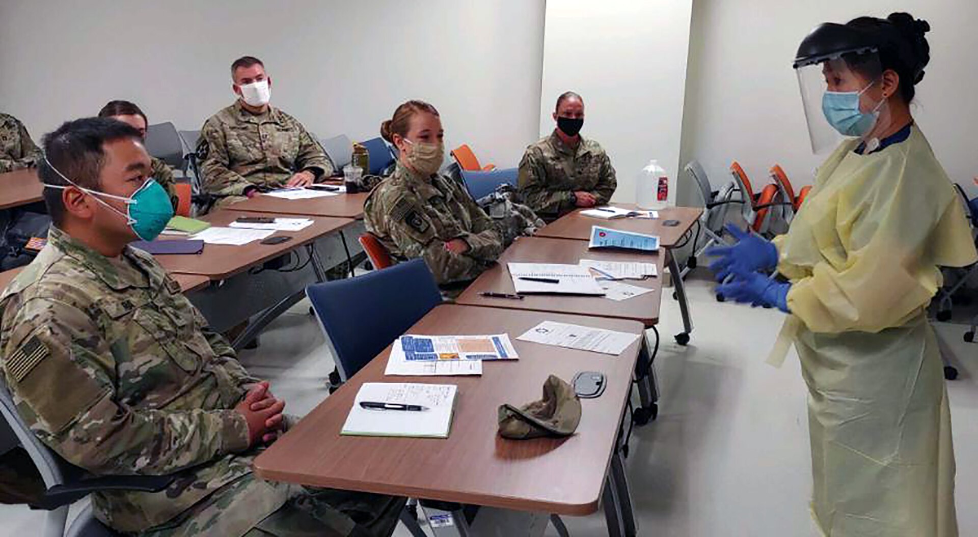 University Hospital integration trainer and Registered Nurse Helena Quezon shows the wear, removal and disposal of personal protective equipment during integration training to Urban Augmentation Medical Task Force-627 Soldiers at University Hospital in San Antonio July 8.