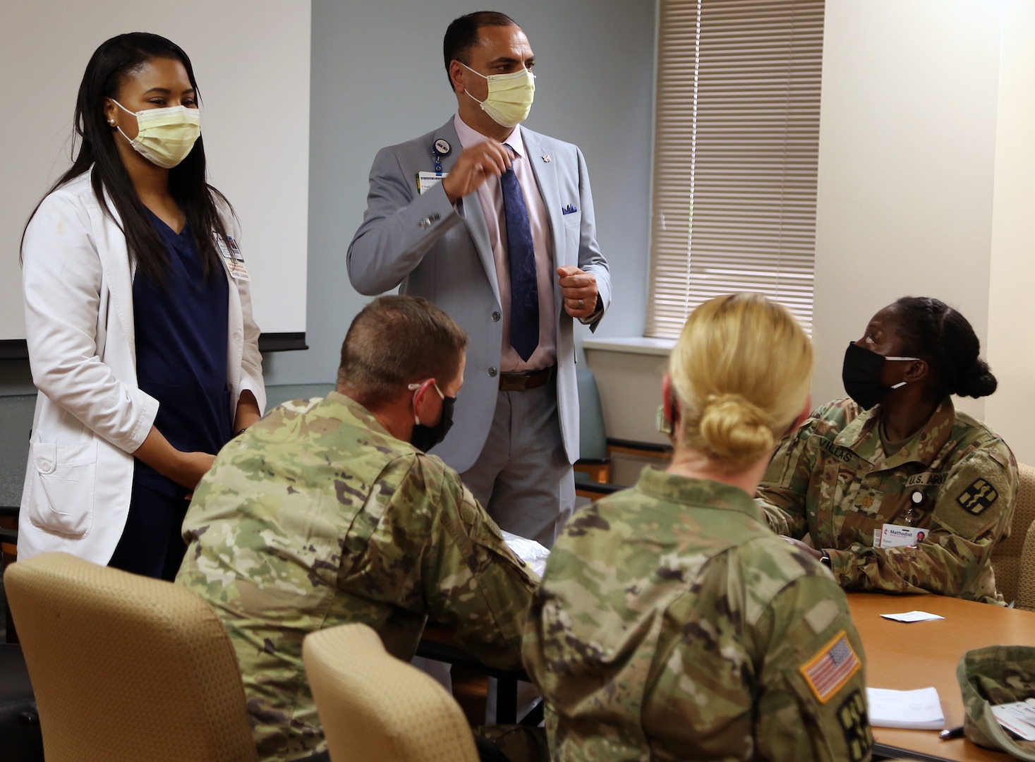 Soldiers from the Urban Augmentation Medical Task Force-627 are briefed by Chadi Awao, Chief Nursing Officer, and Ashley Holmstrom, Assistant Chief Nursing Officer, during integration and training at the Metropolitan Methodist Hospital in San Antonio July 8.