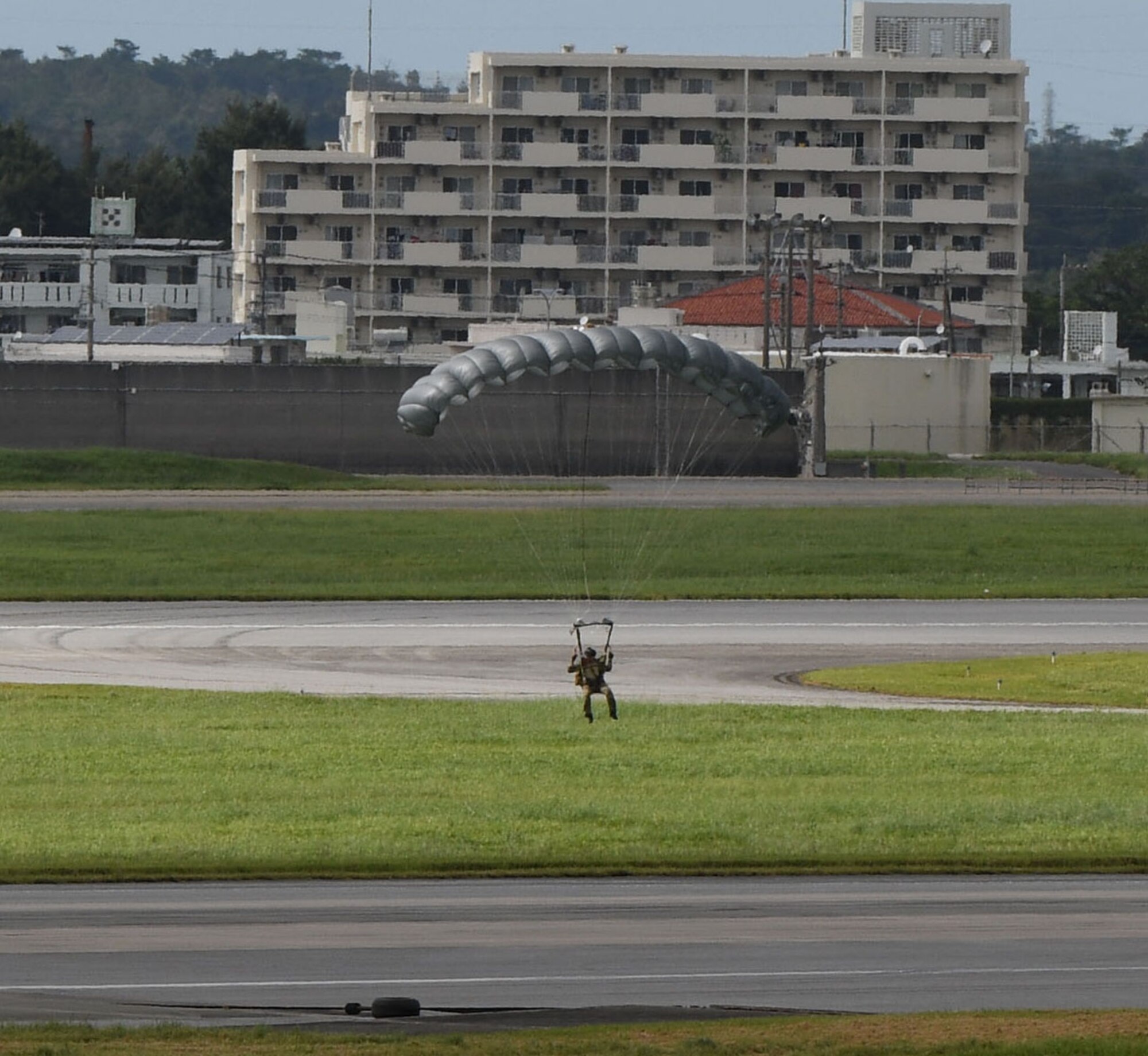Air Force servicemembers conduct paradrop training at the Ridout drop zone July 9, 2020, on Kadena Air Base, Japan. All training on Kadena AB is conducted in accordance with bilateral agreements between the United States and the Government of Japan. Ie Jima is the primary location for overland U.S. military paradrop training in Okinawa. The bilateral agreements allow for the use of Kadena AB as an alternate location when Ie Jima is not available to meet the immediate training needs of U.S. forces.