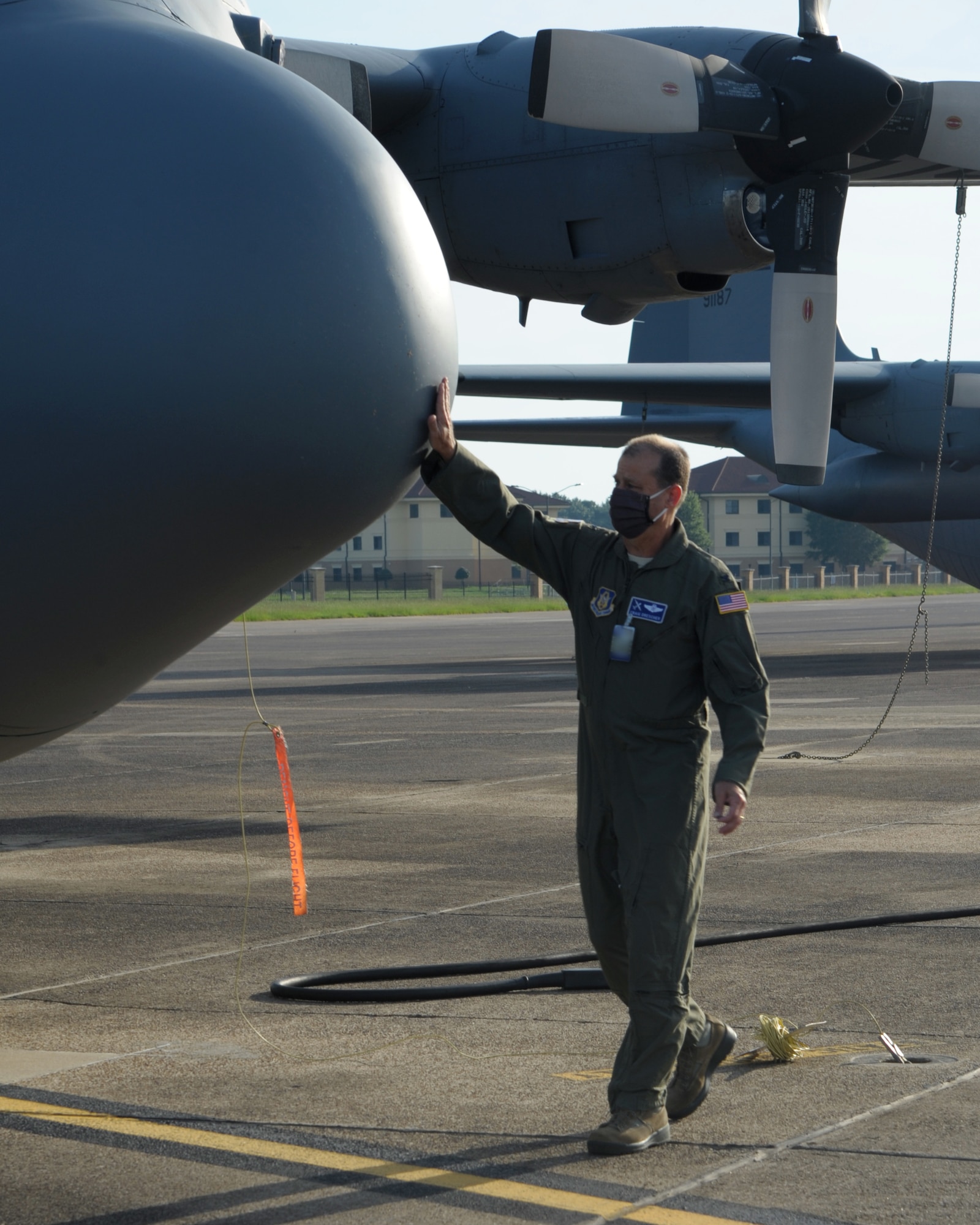 Members walk to the flight line looking for FOD