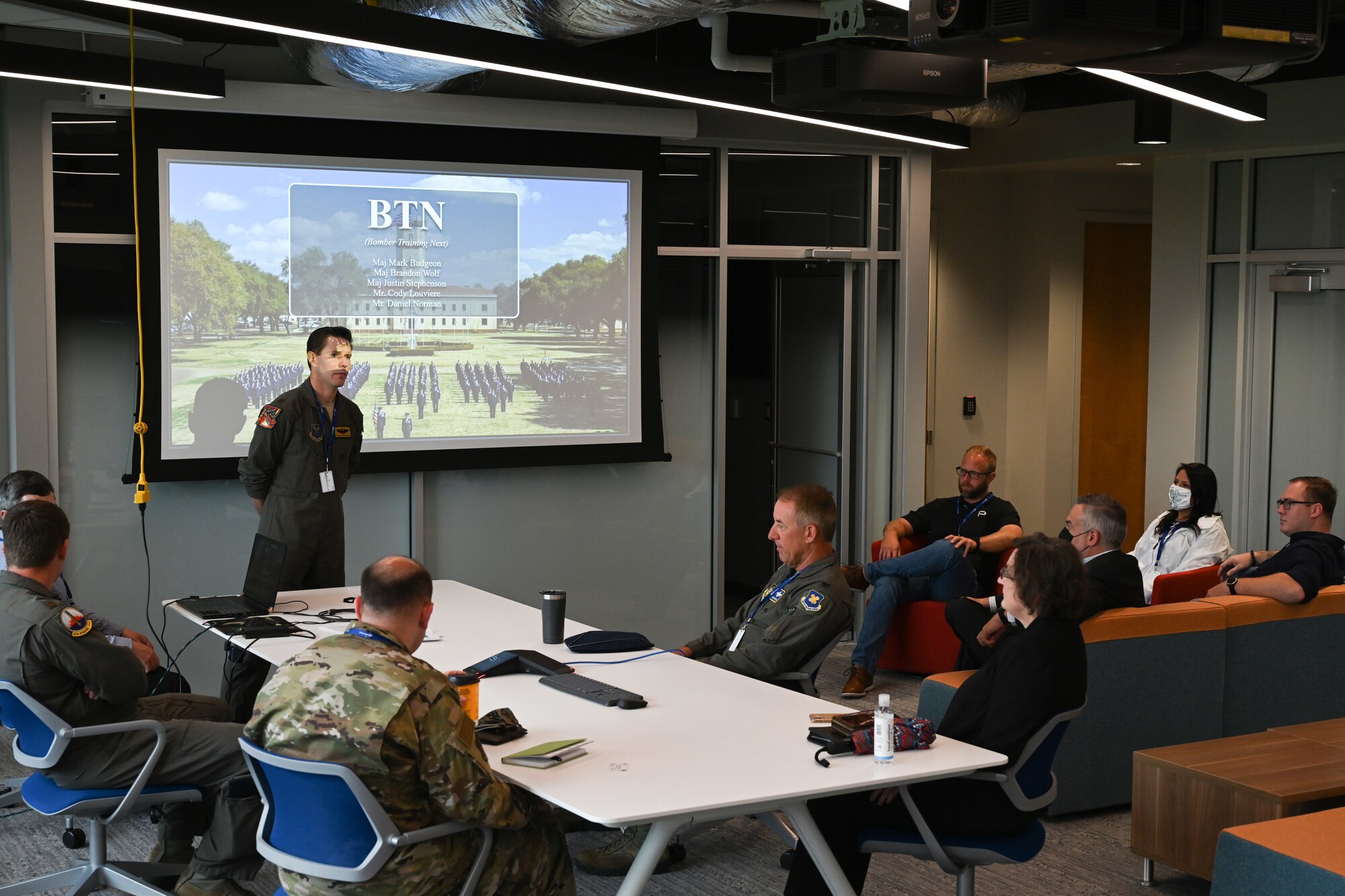 An Airman speaks in front of a gathering.