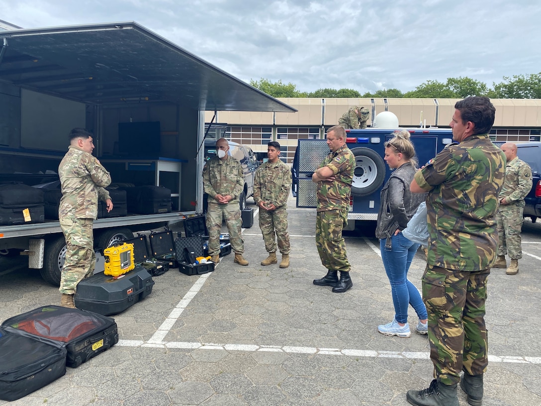 U.S Army Reserve Staff Sgt. William Haynes, survey team member with the 773rd Civil Support Team, 7th Mission Support Command, briefs chemical detection capabilities to Dutch Soldiers in Vught, Netherlands, July 7, 2020. The one-day CBRN situational training exercise focused on a CBRN incident on a maritime vessel at the Dutch Harbor in Gravendeel, Netherlands.  (U.S Army Reserve Photo by Capt. Lorenzo Llorente).
