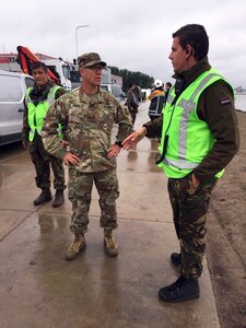 U.S Army Reserve Maj. Blair Heath, medical officer with the 773rd Civil Support Team, 7th Mission Support Command, left, back briefs Netherlands Captain Tom Martens, Netherlands CBRN Defense Centrum Operations Officer, on the medical monitoring status of the 773rd Civil Support Team's survey team during a training exercise in Gravendeel, Netherlands, July 8. The one-day CBRN situational training exercise focused on a CBRN incident on a maritime vessel at the Dutch Harbor in Gravendeel, Netherlands.  (U.S Army Reserve Photo by 1st Sgt. Domenic Barbeiro).