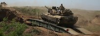 U.S. Soldiers maneuver an M1A1 Abrams Main Battle Tank across an Armored Vehicle Launched Bridge during exercise Allied Spirit at Drawsko Pomorskie Training Area, Poland, June 13, 2020. (U.S. Army photo by Sgt. Randis Monroe)