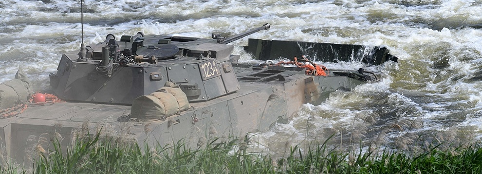 Polish soldiers cross a river in a Rosomak Armoured Personnel Carrier at Drawsko Pomorskie Training Area, Poland, June 13, 2020. (U.S. Army photo by Richard Herman)