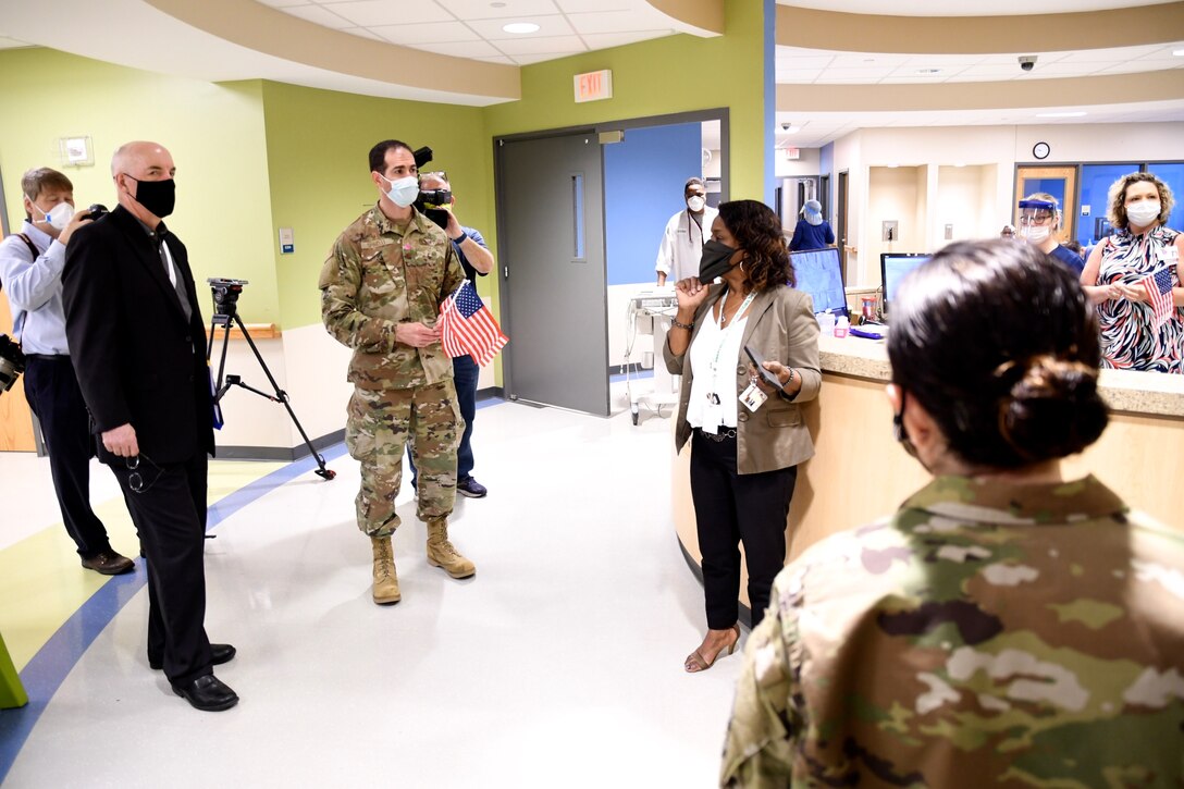 The 932nd Medical Group commander, Col. Chris Spinelli, hands out American flags to nurses and staff during a visit to Touchette Hospital on May 27, 2020, as part of an outreach to thank local medical professionals during the COVID-19 pandemic.  (U.S. Air Force photo by Lt. Col. Stan Paregien)
