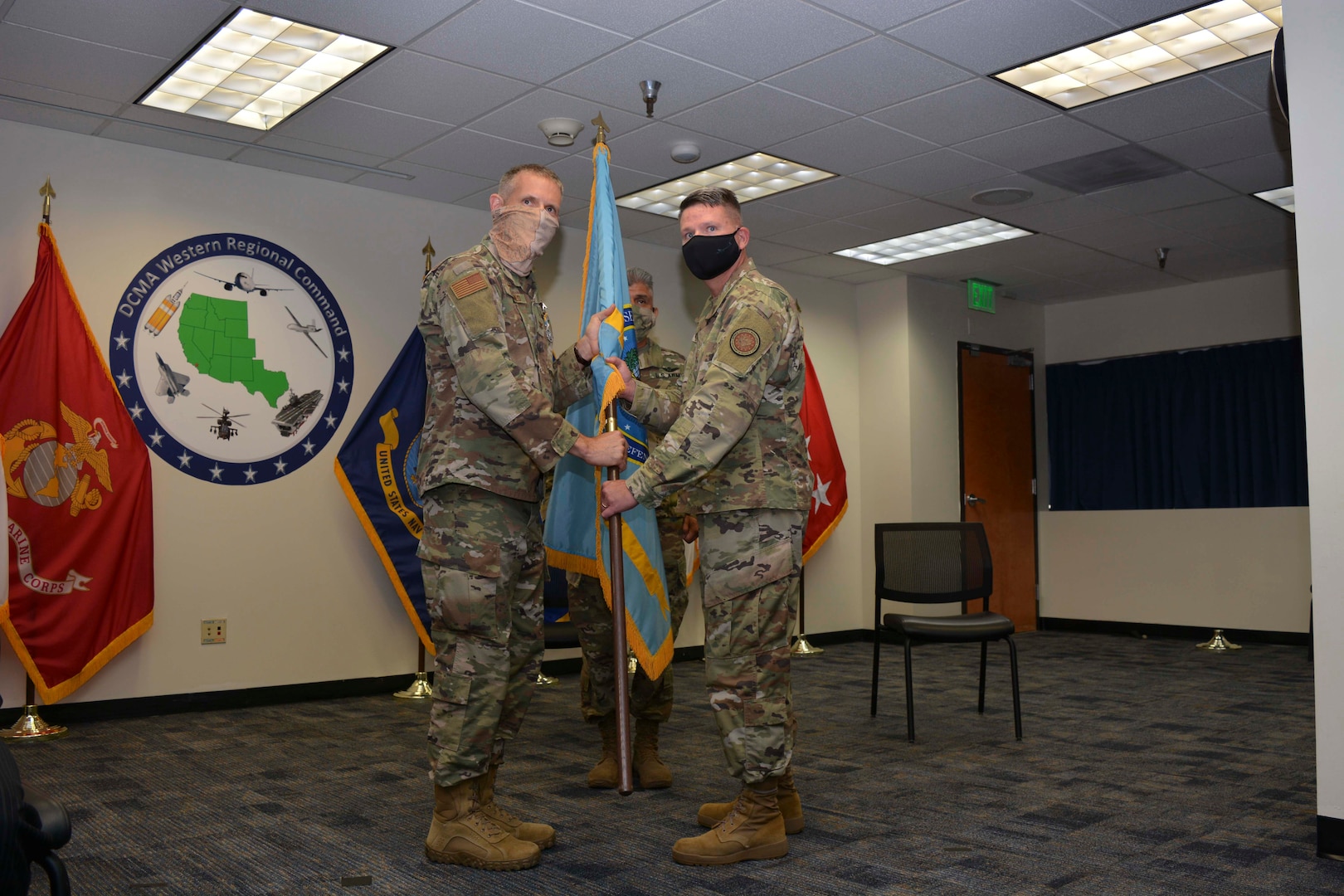 men pose for a photo while holding a flag together