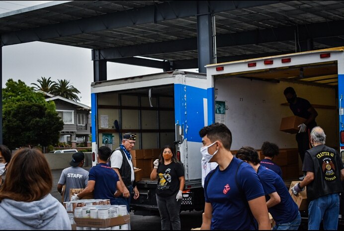 Marine recruiters and future Marines with Recruiting Sub-Station Burbank, Recruiting Station Los Angeles, prepare and sort donated food while volunteering for the Justin and Kourtney Turner Food Bank in Los Angeles, June 20.