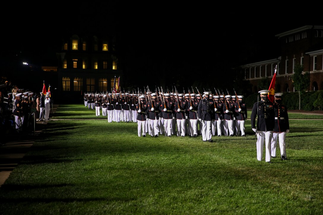 Marines with Marine Barracks Washington conduct “pass in review” during a Friday Evening Parade at Marine Barracks Washington, D.C., July 7, 2020. Admiral Michael M. Gilday, chief of naval operations, was the guest of honor, and the hosting official was the 38th Commandant of the Marine Corps, Gen. David H. Berger. (U.S. Marine Corps photo by Cpl. James Bourgeois)