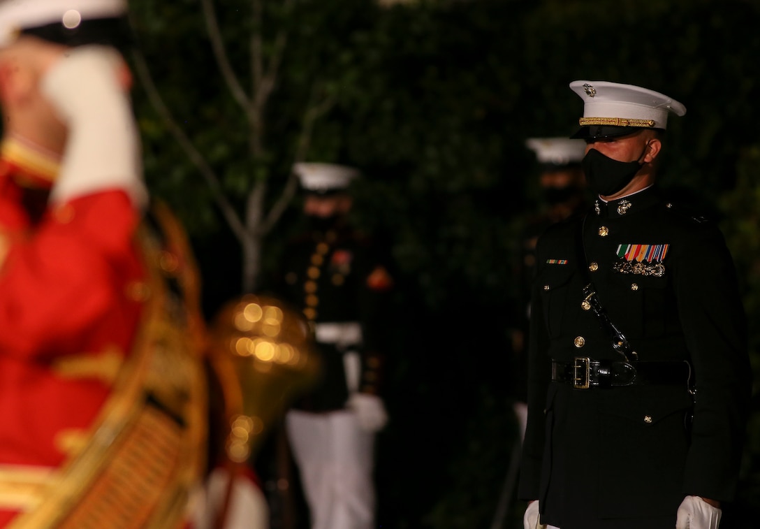 Captain Mason Graham, company commander, Bravo Company, Marine Barracks Washington, stands at attention during a Friday Evening Parade at Marine Barracks Washington, D.C., July 7, 2020. Admiral Michael M. Gilday, chief of naval operations, was the guest of honor, and the hosting official was the 38th Commandant of the Marine Corps, Gen. David H. Berger. (U.S. Marine Corps photo by Sgt. Robert Knapp)