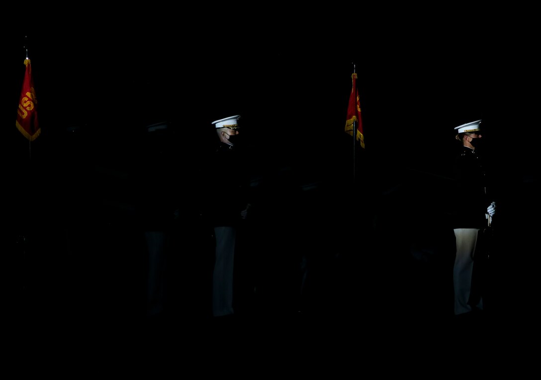 Major Dale Chung, parade commander, and Capt. Caroline Locksmith, parade adjutant, Marine Barracks Washington, perform during a Friday Evening Parade at Marine Barracks Washington, D.C., July 7, 2020. Admiral Michael M. Gilday, chief of naval operations, was the guest of honor, and the hosting official was the 39th Commandant of the Marine Corps, Gen. David H. Berger. (U.S. Marine Corps photo by Sgt. Robert Knapp)