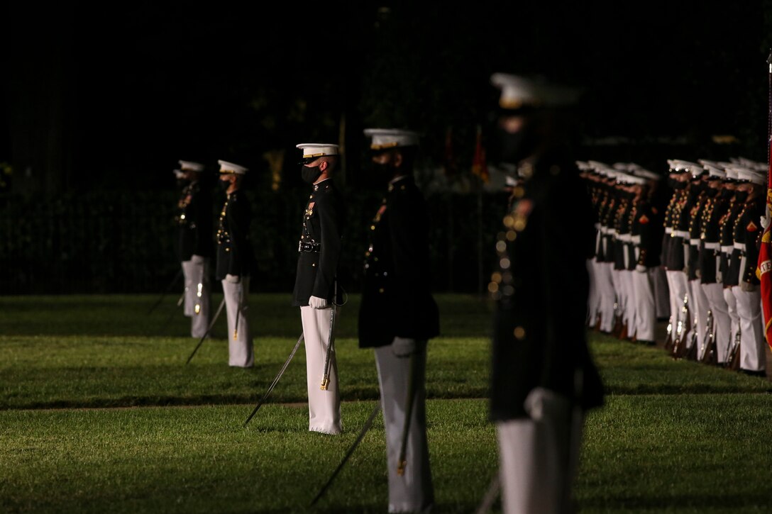 Marines with Marine Barracks Washington perform during a Friday Evening Parade at Marine Barracks Washington, D.C., July 7, 2020. Admiral Michael M. Gilday, chief of naval operations, was the guest of honor, and the hosting official was the 38th Commandant of the Marine Corps, Gen. David H. Berger. (U.S. Marine Corps photo by Sgt. Robert Knapp)