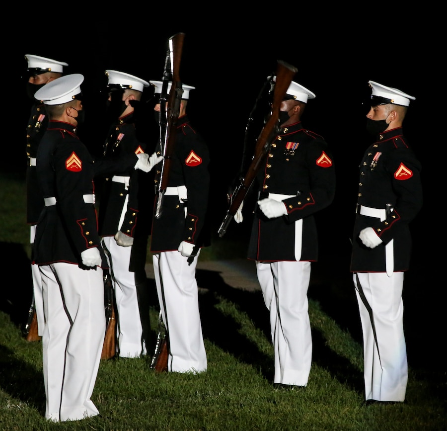 Marines with the Silent Drill Platoon execute their “rifle inspection” sequence during a Friday Evening Parade at Marine Barracks Washington, D.C., July 7, 2020. Admiral Michael M. Gilday, chief of naval operations, was the guest of honor, and the hosting official was the 38th Commandant of the Marine Corps, Gen. David H. Berger. (U.S. Marine Corps photo by Sgt. Robert Knapp)