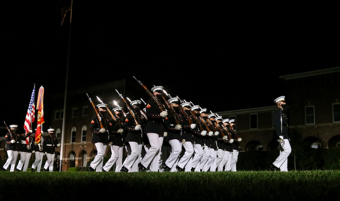 Marines with Marine Barracks Washington execute “pass in review” during a Friday Evening Parade at Marine Barracks Washington, D.C., July 7, 2020. Admiral Michael M. Gilday, chief of naval operations, was the guest of honor, and the hosting official was the 38th Commandant of the Marine Corps, Gen. David H. Berger. (U.S. Marine Corps photo by Sgt. Robert Knapp)