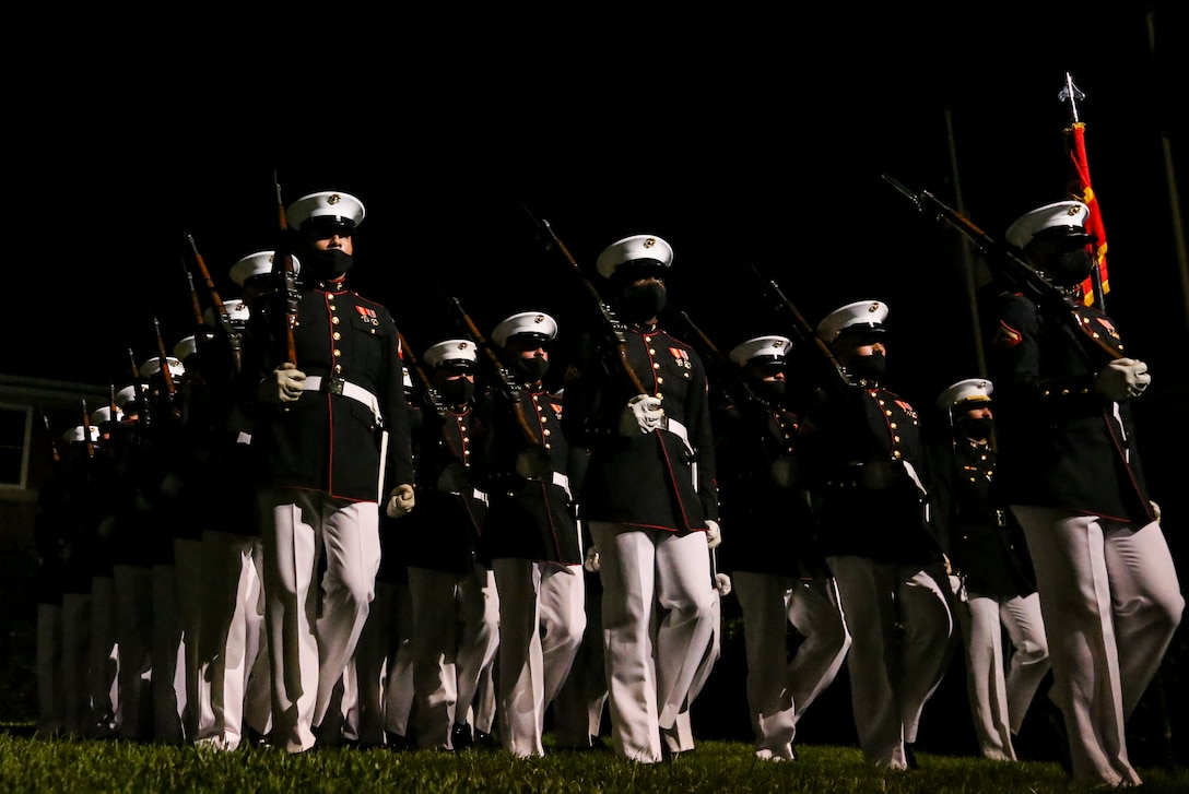 Marines with Bravo Company, Marine Barracks Washington, execute “pass in review” during a Friday Evening Parade at Marine Barracks Washington, D.C., July 7, 2020. Admiral Michael M. Gilday, chief of naval operations, was the guest of honor, and the hosting official was the 38th Commandant of the Marine Corps, Gen. David H. Berger. (U.S. Marine Corps photo by Sgt. Robert Knapp)