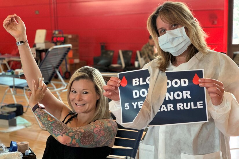 Two women smile at the camera.