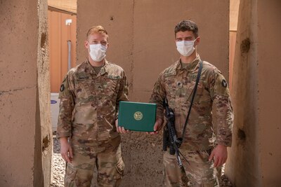 Spc. Cameron Kerkes is presented an Army Achievement Medal on July 7, 2020, for earning the U. S. Army Central’s Paralegal of the Quarter competition for the 3rd quarter of 2020. The AAM is presented by Kerkes’ sponsor for the competition, Sgt. Joshua Snyder while they are both deployed to the Middle East with the Headquarters & Headquarters Company, 2-147th Assault Helicopter Battalion, 34th Expeditionary Combat Aviation Brigade. (U.S. Army photo by Sgt. Sydney Mariette)