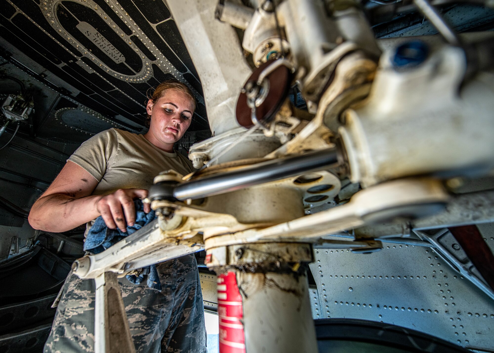 Senior Airman Carissa White, a crew chief with the 910th Maintenance Squadron, conducts a pre-flight maintenance check on Youngstown Air Reserve Station’s flightline, July 7, 2020. White was working underneath the nose of a C-130H Hercules aircraft inspecting the front landing gear.
