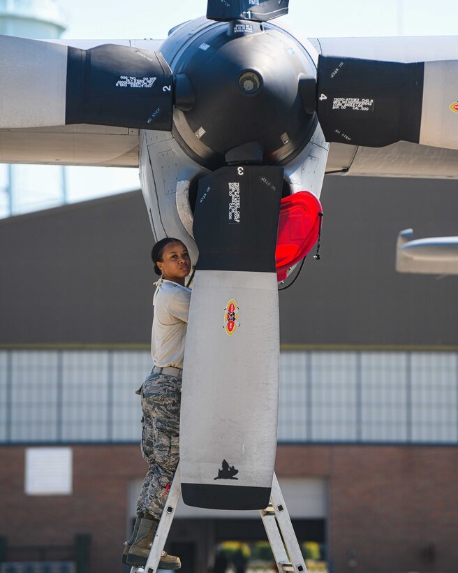 Senior Airman Dayna Jones, a crew chief with the 910th Maintenance Squadron, watches two planes take off while performing a thru-flight inspection on a C-130H Hercules on Youngstown Air Reserve Station’s flightline, July 7, 2020. Crew chiefs use thru-flight inspections to search for any loose, broken or corroded parts and foreign material prior to takeoff.